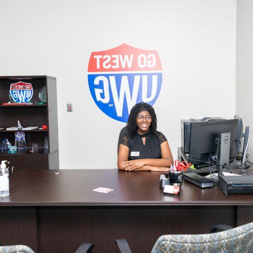 student behind office desk